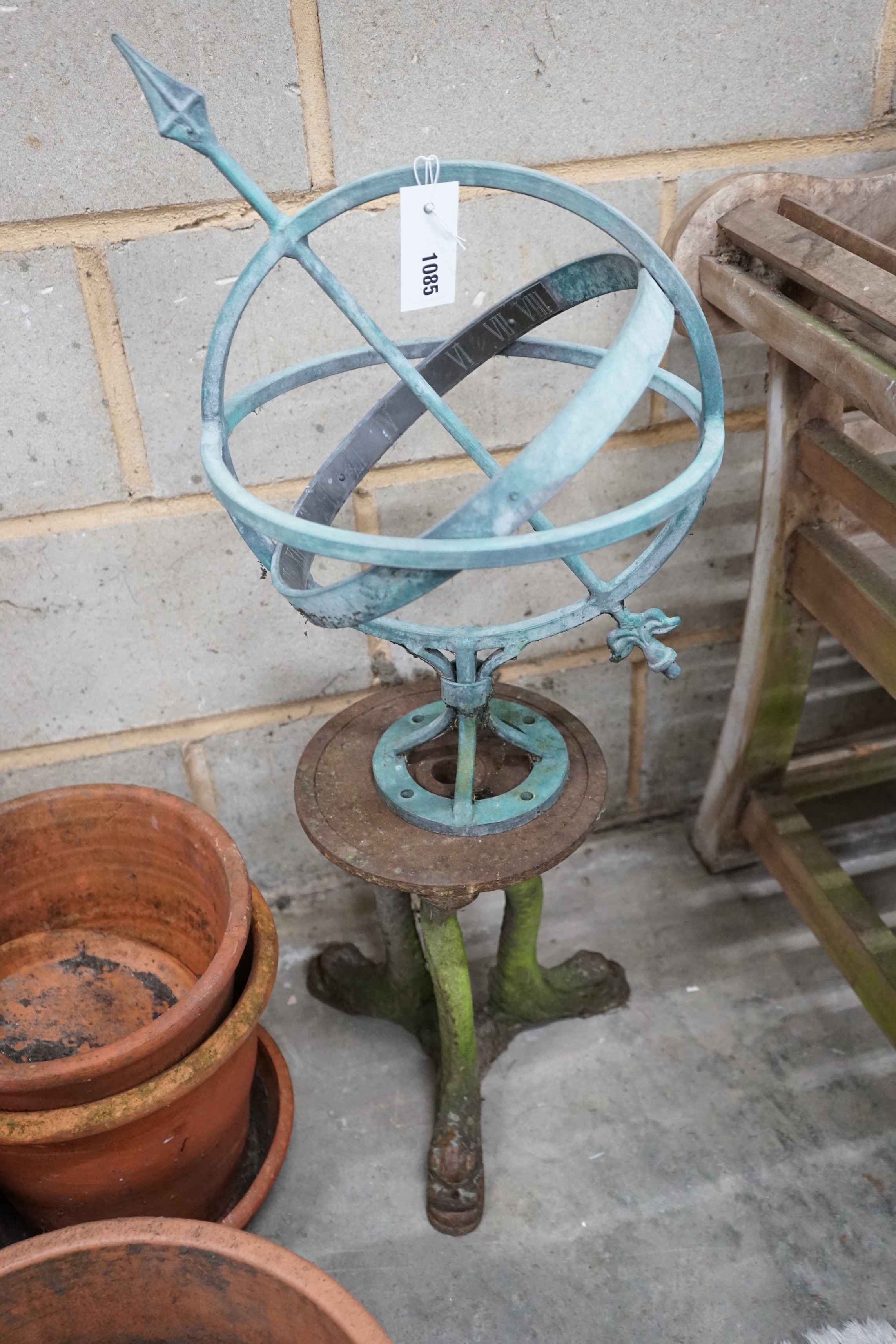 Twelve assorted terracotta garden planters with assorted dish bases, a metal sphere on cast iron stand and a reconstituted stone statue